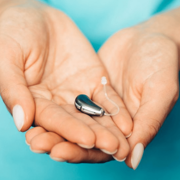 hands holding a hearing aid